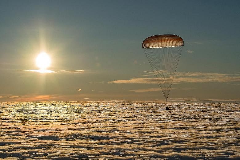 This image shows the Soyuz MS-06 capsule, carrying the crew of American astronauts Joe Acaba and Mark Vande Hei as well as Russian cosmonaut Alexander Misurkin, descending just before landing in a remote area outside the town of Dzhezkazgan, Kazakhst