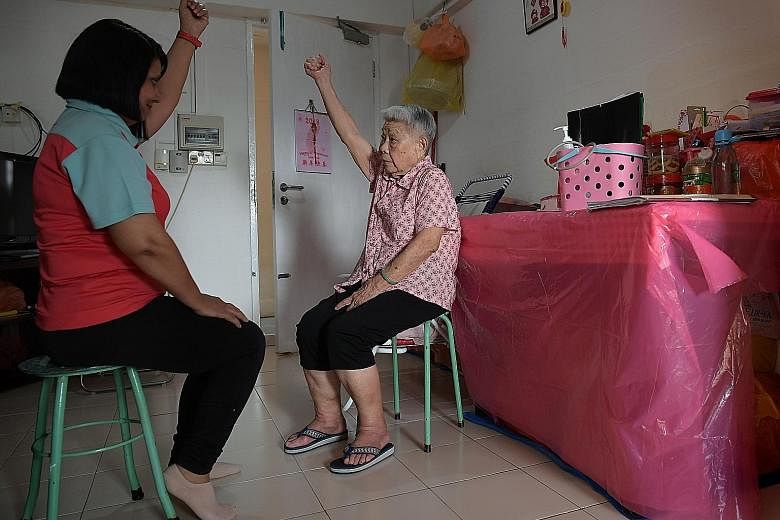 Care coordinator Poonam Bala, 50, manages the health needs of Madam Lock Ah Sim, 86. She takes Madam Lock's blood pressure, checks her medication and does light exercises with her. Madam Lock is part of the Care Close to Home programme, which helps s