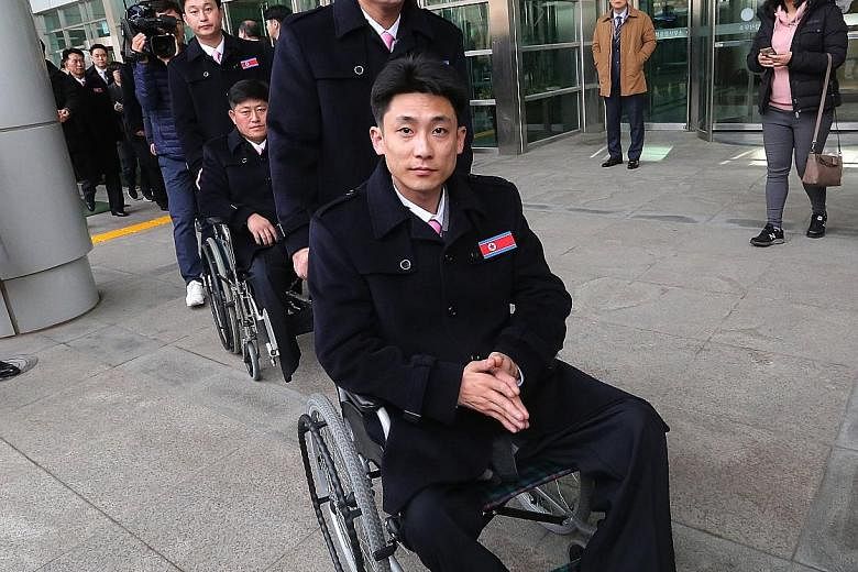 North Korean athletes arriving for the Pyeongchang Paralympic Games near the Demilitarised Zone in Paju, South Korea, yesterday. Inter-Korean ties have thawed after Pyongyang launched a charm offensive in January. Mr Chung Eui Yong (left), head of a 