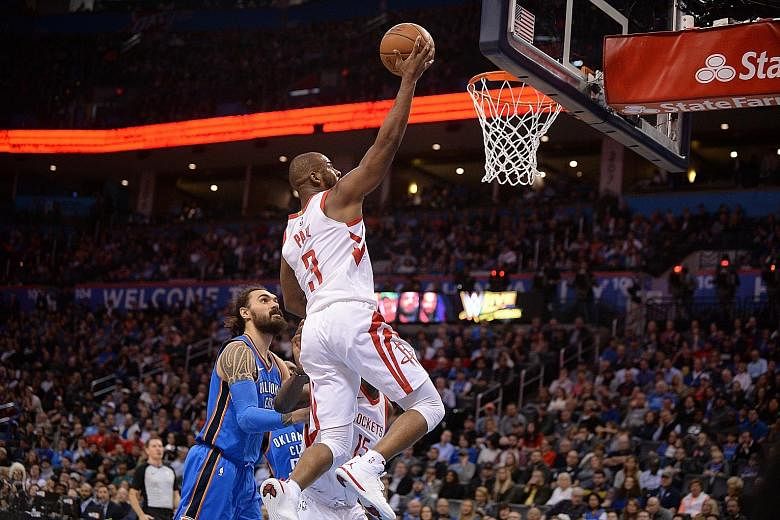 Houston Rockets guard Chris Paul driving to the basket during the second quarter of his team's 122-112 win over the Oklahoma City Thunder at Chesapeake Arena. Paul stole the show after converting five of six three-pointers to help the Rockets become 