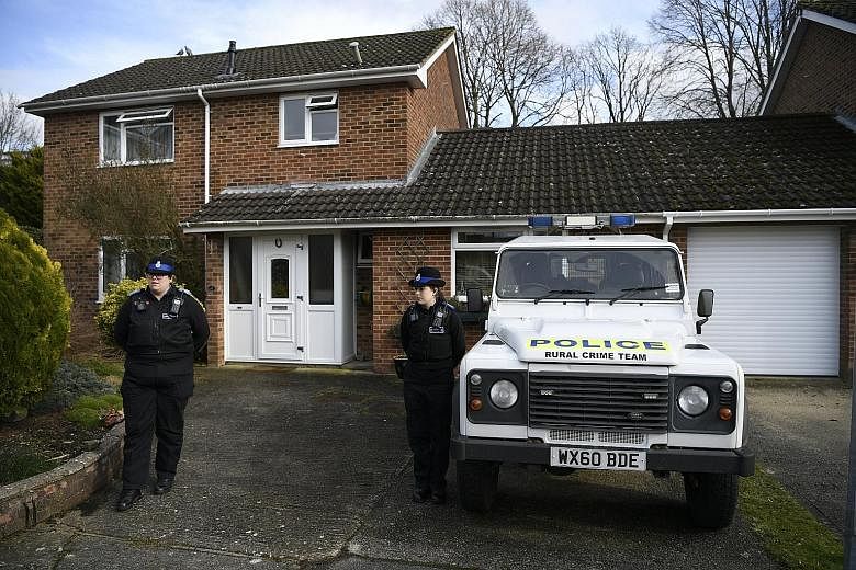 Police standing guard outside what is believed to be the home of former Russian spy Sergei Skripal (above) in Salisbury, Britain, on Tuesday.
