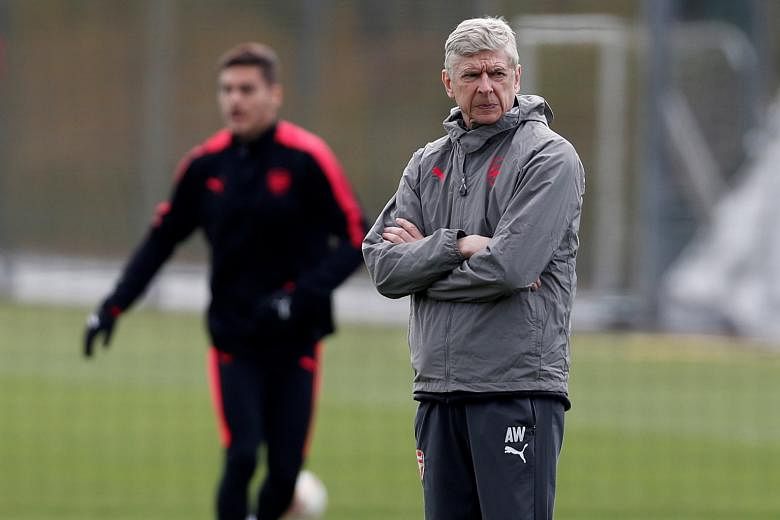 Arsenal manager Arsene Wenger during training yesterday, as his side prepared to meet AC Milan in a Europa League tie today. A growing pay divide is said to have split the dressing room, while an overwhelming majority of the Arsenal Supporters' Trust