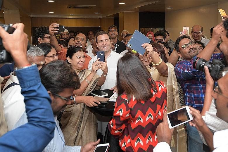 Members of the Indian diaspora taking selfies with India's opposition leader and Congress party president Rahul Gandhi at the Singapore Indian Association during his visit to Singapore that concludes today. 	Mr Gandhi, scion of India's Nehru-Gandhi d