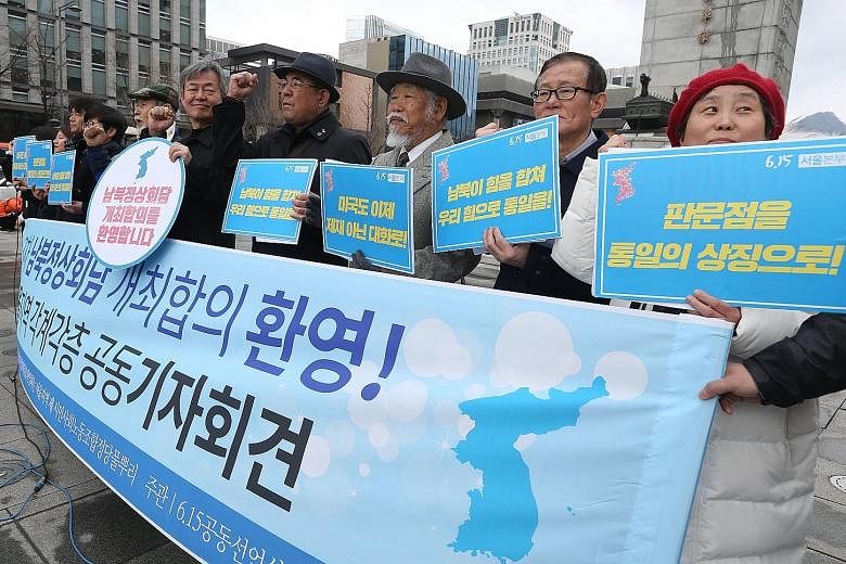 Members of an opposition group with banners that read "Welcome inter-Korean Summit" in Seoul. The South Korean envoys reached a number of agreements, including plans for an inter-Korean summit, during their trip to the North.