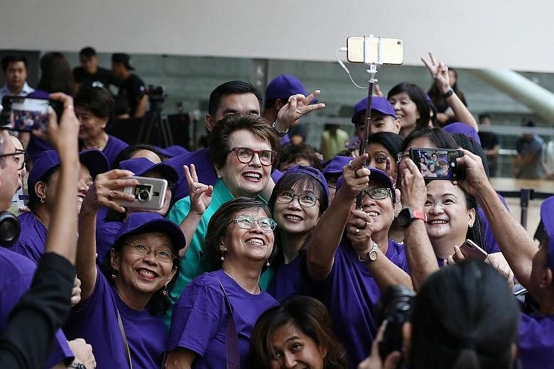 Women's Tennis Association founder Billie Jean King having a wefie taken with volunteers of the WTA Singapore yesterday.