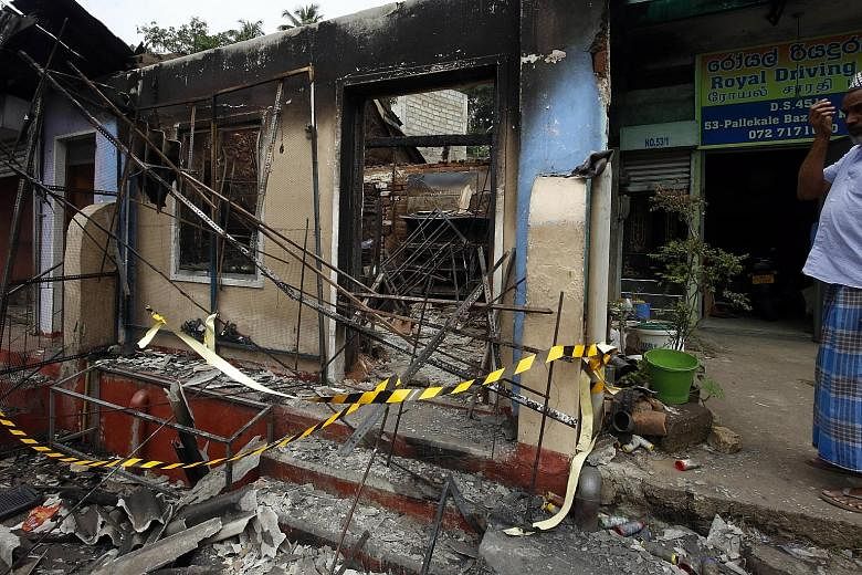A Muslim man from the Moor community surveying the damage to his business, which was attacked and looted in Pallekele town in Kandy, some 117km from Colombo, on Wednesday.
