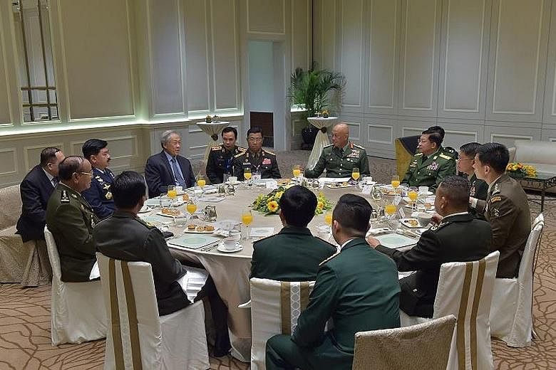 The Asean defence forces chiefs having breakfast with Defence Minister Ng Eng Hen (in blue shirt and tie) yesterday, during which they discussed regional security issues and the Asean militaries' agenda for the year ahead.