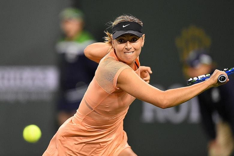 Maria Sharapova hitting a return against Naomi Osaka during their first-round match at Indian Wells. The former world No. 1 dropped serve five times in her 6-4, 6-4 defeat by the Japanese world No. 44. The Russian was also knocked out in the opening 