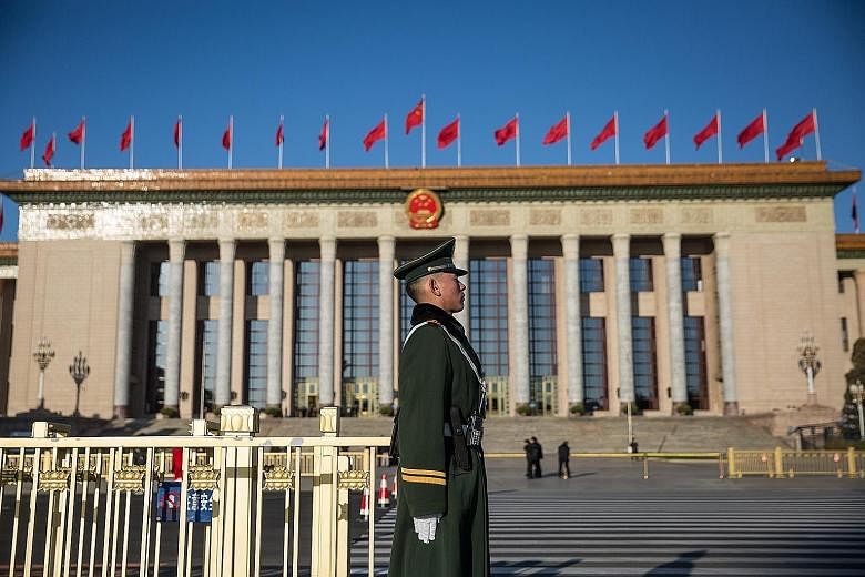 A People's Liberation Army soldier standing guard in Beijing yesterday. Chinese Foreign Minister Wang Yi said China was not a threat to the world, noting that the country was a leading contributor to global economic growth.