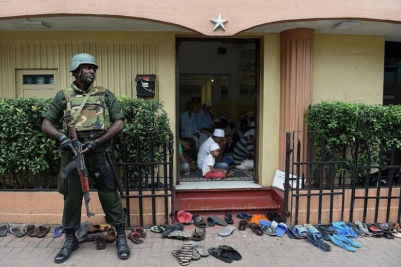 A Sri Lankan soldier guarding a mosque in Colombo yesterday. Police said tight security remained in place for the fifth consecutive day in Kandy and would remain across the district for the coming few days.