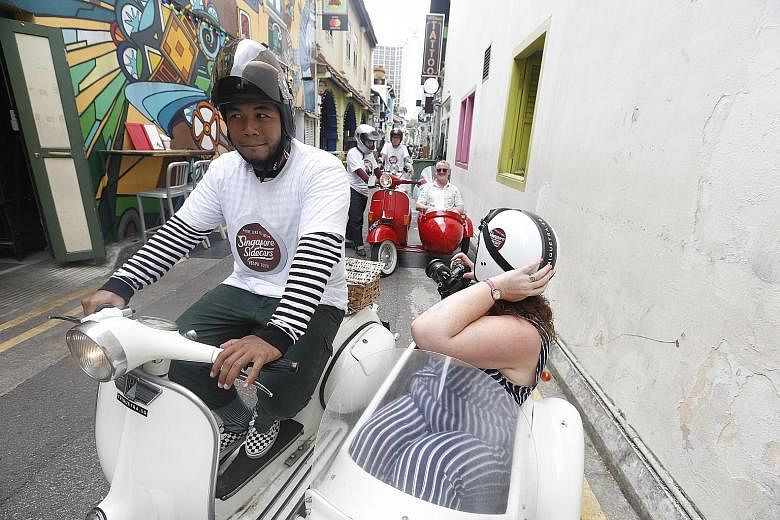 Scottish tourist Laura McAlpine and her husband setting off from Haji Lane for a unique tour in the sidecars of vintage Vespas. The tour, run by Singapore Sidecars, takes tourists off the beaten track around Singapore.