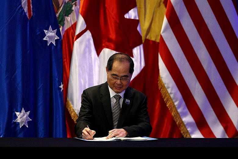 Singapore's Minister for Trade and Industry (Trade) Lim Hng Kiang signing the trade deal in Santiago on Thursday. Singapore is expected to be the second-biggest winner from the CPTPP after Malaysia, said Moody's, citing a report.