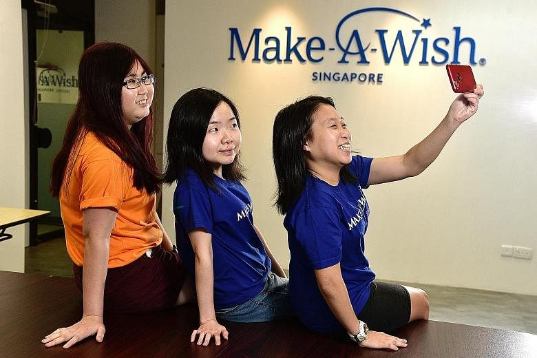 Former beneficiaries (from far left) Theresa Thang, Elina Toh and Sarah Tan see volunteering at Make-A-Wish Singapore as a way to bring joy to children.