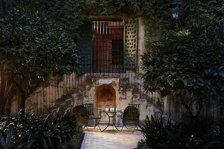 Hotel Las Casas de la Juderia (above) is a collection of elegant 15th-century Andalusian townhouses and flower-filled courtyards in the heart of Seville, Spain.