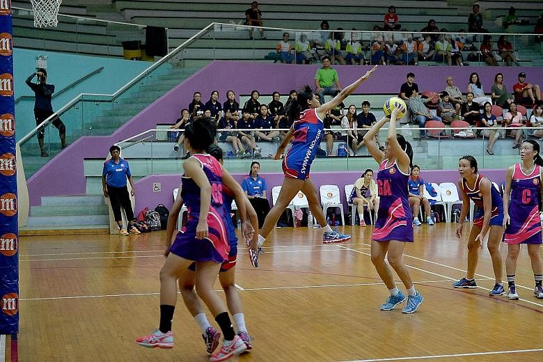 Mission Mannas goal defender Nurul Baizura attempting to block Sneaker Stingrays goal attacker Toh Kai Wei's shot. The Stingrays returned after a year out of the Netball Super League to edge out defending champions Mannas 58-57 in the season opener.