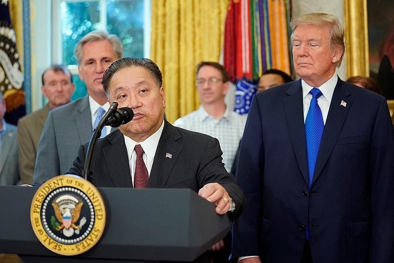 Broadcom chief executive Tan Hock Eng with US President Donald Trump at the Oval Office of the White House in Washington last November, where Mr Tan announced plans to relocate Broadcom's global headquarters from Singapore to the US.