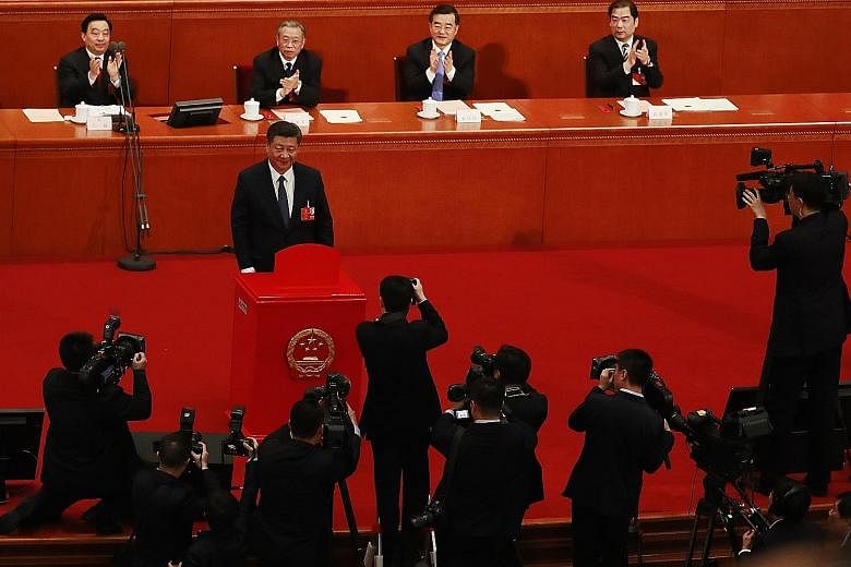 Chinese President Xi Jinping casting his vote on a proposal that included the amendment to abolish the two-term limit of the presidency, at a plenary meeting of the ongoing annual National People's Congress session in Beijing yesterday.