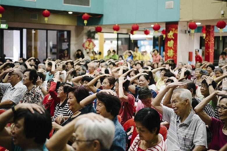 The crowd at the Bukit Panjang Community Club on Sunday engaging in a mass demonstration of dual-task activities - which have been shown to help improve memory - under the Healthy Ageing Promotion Programme For You.