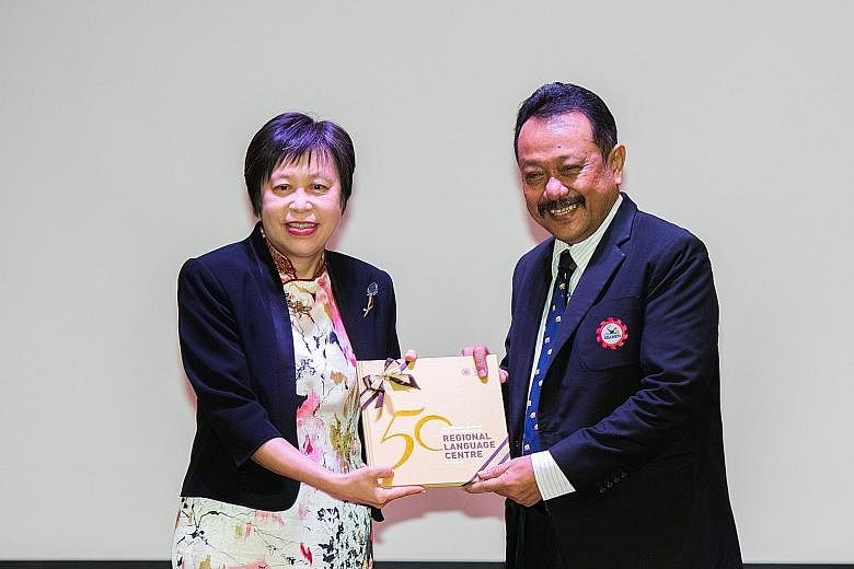 Seameo secretariat director Gatot Priowirjanto was presented with a copy of the commemorative book by Ms Susan Leong, director of the Seameo RELC Centre.