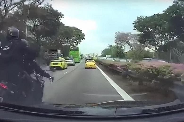 A video taken from a car's dashboard camera showing two motorcycles brushing against each other before toppling. The video ends with the police officers falling to the ground.
