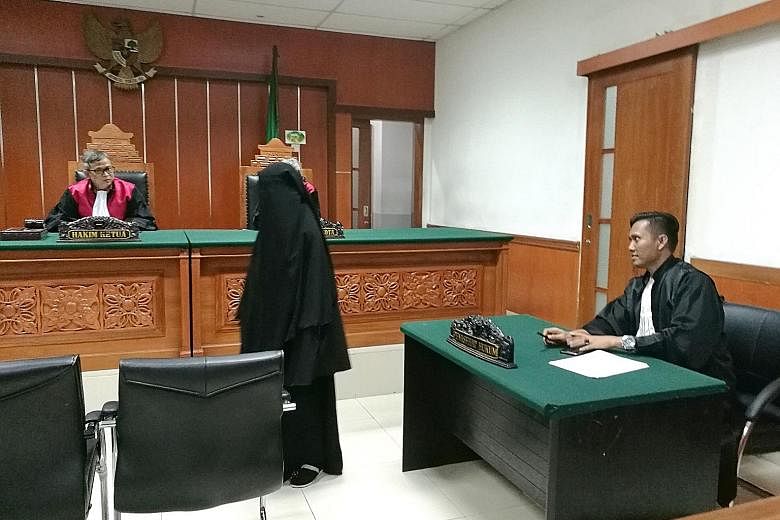 Former migrant worker Anggi Indah Kusuma appearing in a West Jakarta district court last week. She and her husband face charges related to planning terror attacks and making explosives in a rented house in Bandung.