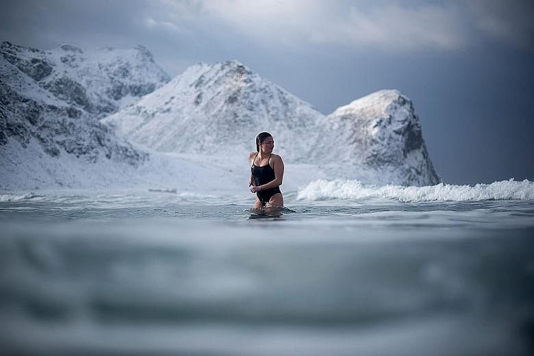A young woman taking a quick dip in Unstad in northern Norway's Lofoten islands, within the Arctic Circle, on Sunday. The air temperature was a chilly -5 deg C, while the water temperature was 4 deg C.