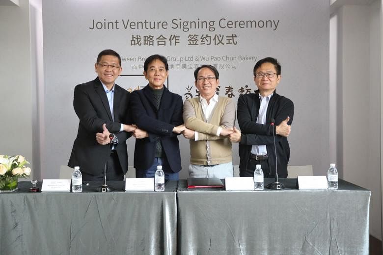 (From far left) BreadTalk Group chief executive Henry Chu and chairman George Quek, with Wu Pao Chun Food founder Wu Pao Chun and executive vice-president David Chiu at the joint venture signing ceremony.