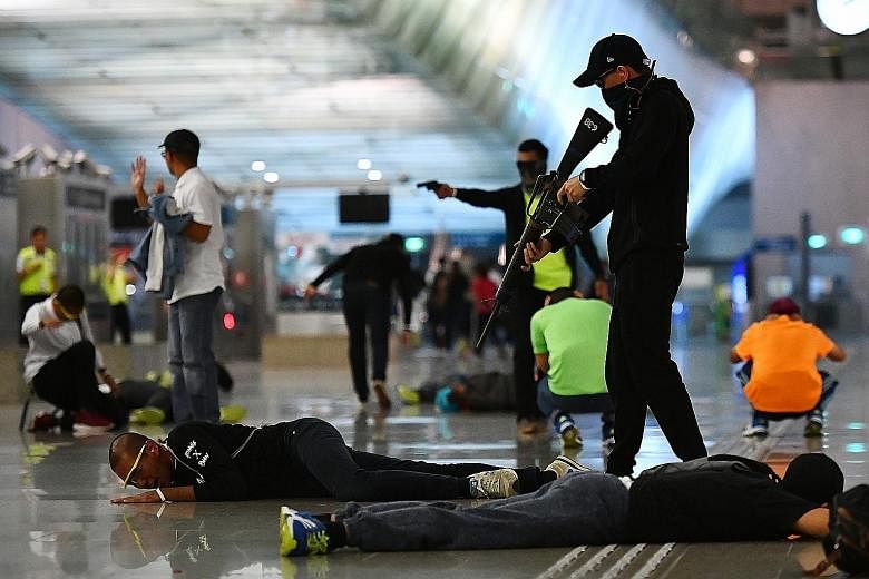 "Gunmen" attacking commuters at Changi Airport MRT station during a counter-terrorism exercise last year. The Ministry of Home Affairs budget for this year shows clear increases in overall spending on security even as governments in the region prepar