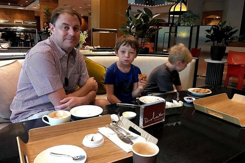 Mr Blair Haynes and his two children, Baxter (middle) and Flynn. His family booked through Airbnb's website (below) the two-bedroom unit in Caribbean at Keppel Bay for four nights. But the family was turned away last Friday by security guards at the 