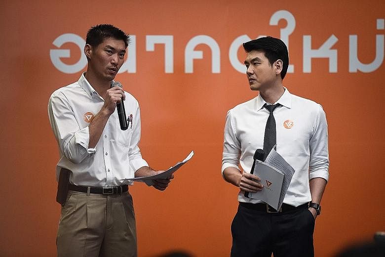 Tycoon Thanathorn Juangroongruangkit (left) and Assistant Professor Piyabutr Sangkanokkul, the co-founders of Future Forward, at the party's official launch event in Bangkok yesterday.