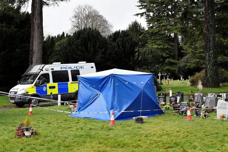 A police van and a tent covering the headstone of Alexander Skripal, the son of former Russian double agent Sergei Skripal, in Salisbury in Britain yesterday. The former spy and his daughter Yulia were found unconscious on a bench in the city on Marc