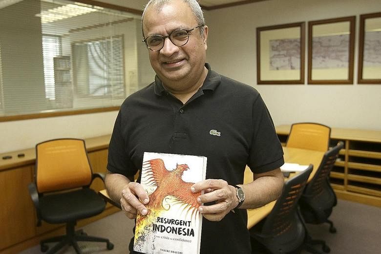 Public affairs strategist Vasuki Shastry with his book, Resurgent Indonesia: From Crisis To Confidence, at The Straits Times bureau in Jakarta on Tuesday. The former Indonesia bureau chief for The Business Times hopes to show how Indonesia blended de