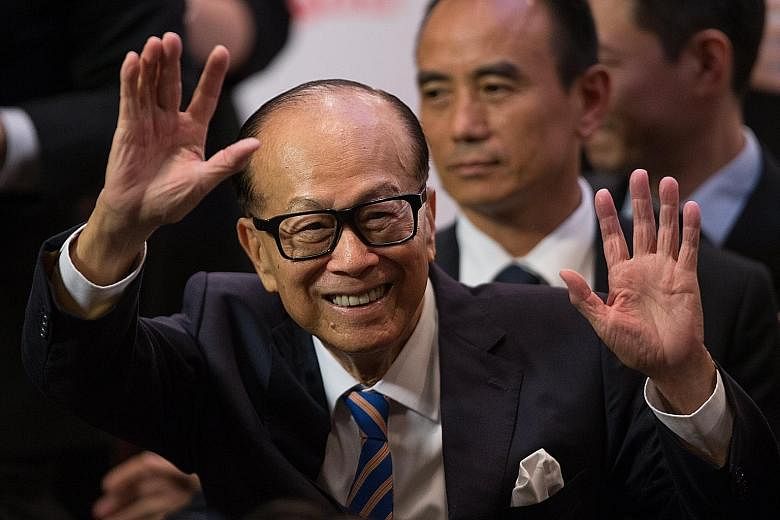 Mr Li Ka Shing leaving a packed news conference in Hong Kong after his announcement yesterday. His retirement remarks came on a high note as Mr Li's four biggest companies - CK Hutchison, CK Asset, CK Infrastructure Holdings and Power Assets Holdings