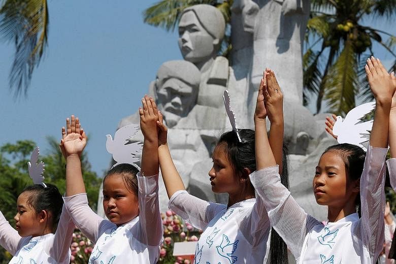 Schoolgirls at yesterday's ceremony marking the My Lai massacre, where American soldiers killed 504 people in Son My, a collection of hamlets between the central Vietnamese coast and a ridge of mountains.