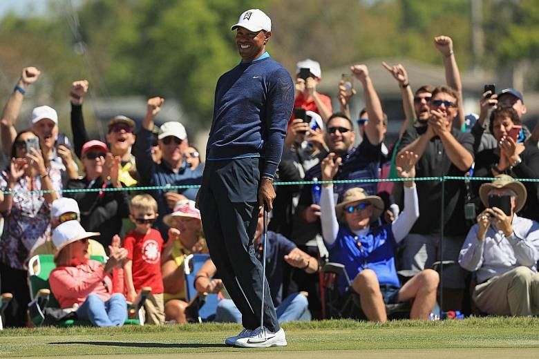 Tiger Woods and fans reacting to his birdie putt on the seventh hole during his first-round 68 at the Arnold Palmer Invitational at Bay Hill, Florida, on Thursday.