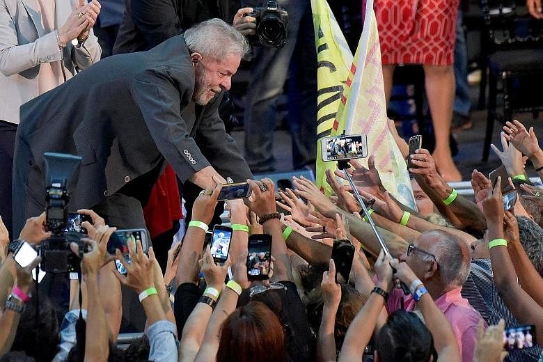 Mr Luiz Inacio Lula da Silva greeting supporters at a rally in Belo Horizonte, Brazil, on Feb 21. Mr da Silva is a frontrunner in the presidential polls and also reportedly the leading target of negative fake news stories.
