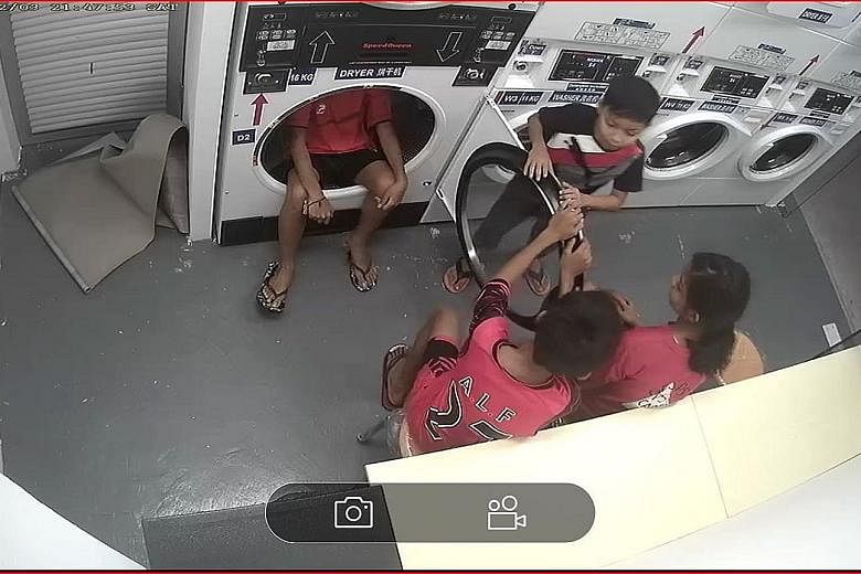 CCTV image of children turning a self-service laundromat into a playground. Instawash Laundry Services says children are often seen squeezing themselves inside the machines.