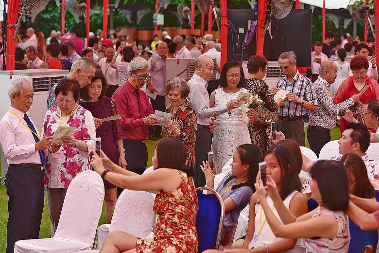 Senior couples reciting a love declaration in front of guests at the Golden Jubilee Wedding Celebrations at the Istana yesterday. President Halimah Yacob was the guest of honour at the event.