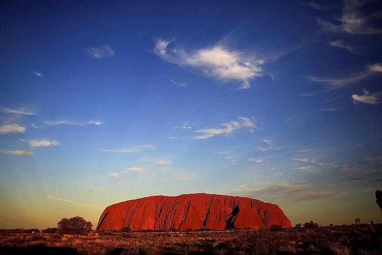 Tourists climbing Uluru. Since 1992, a sign at the base of the sandstone rock has asked people not to climb out of respect for the traditional Aboriginal owners. Data commissioned by the parks authority found that 16 per cent of visitors now climb Ul
