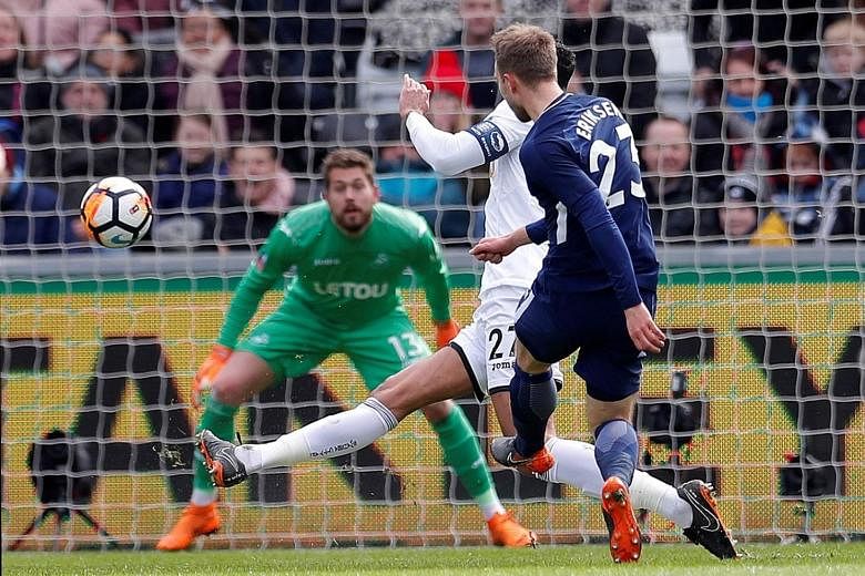 Tottenham's Christian Eriksen scoring the opening goal in the 3-0 FA Cup quarter-final win at Swansea's Liberty Stadium yesterday. Spurs will play the semi-final at their temporary home of Wembley next month.