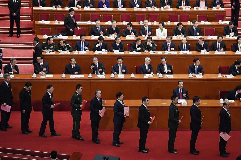 President Xi Jinping casting his vote at the NPC session. He has been unanimously elected to a second term, days after the lifting of presidential term limits allowed him to stay in office indefinitely. Delegates lining up to vote during the fifth pl