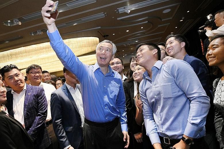 Prime Minister Lee Hsien Loong taking a wefie with Singaporean students in Sydney yesterday, at a reception for overseas Singaporeans held at the Shangri-La Hotel, in conjunction with his visit to Australia to attend the Asean-Australia Special Summi