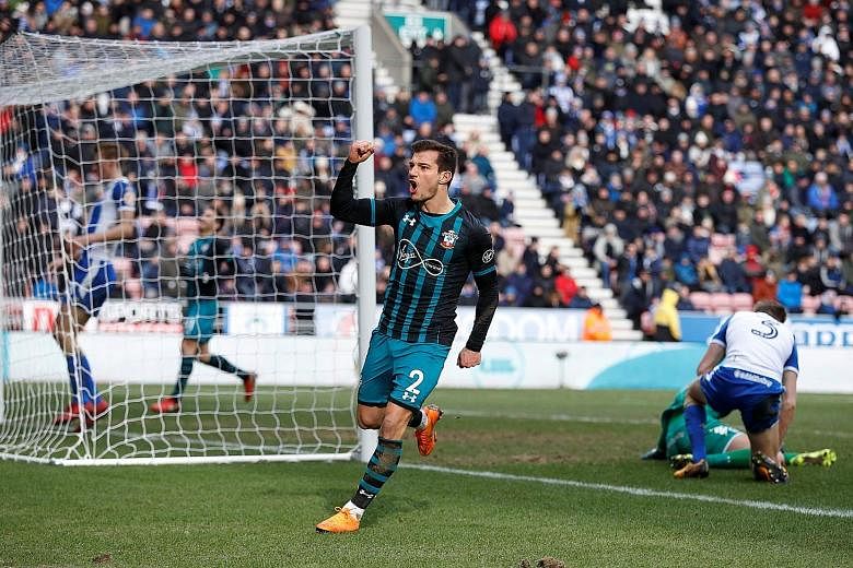 Southampton defender Cedric Soares celebrating after his 91st-minute goal against Wigan sealed a 2-0 win at the DW Stadium yesterday, sending the Saints through to the FA Cup semi-finals for the first time in 15 years. Midfielder Pierre-Emile Hojbjer