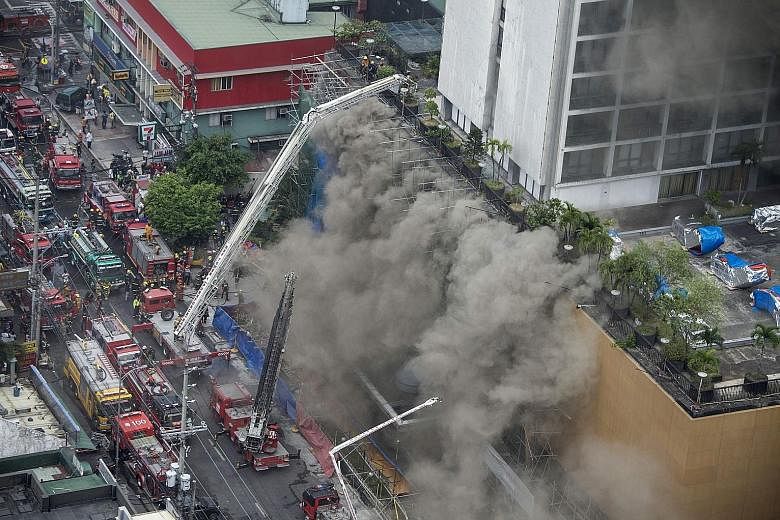 Above: A fireman receiving first aid from colleagues. He had been rescued after being trapped by thick smoke as he battled a fire that engulfed Waterfront Manila Pavilion, a high-rise hotel and casino complex yesterday. Left: Firemen fighting the fla