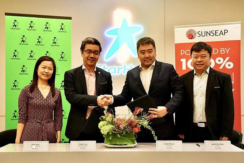 (From left) StarHub's vice-president of corporate finance Karie Kow and chief marketing officer Howie Lau with Sunseap's co-founder and chief executive Frank Phuan and vice-president of energy Laurence Kwan. StarHub and Sunseap will offer customers a
