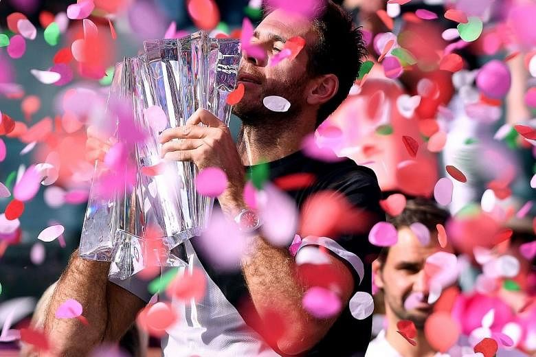 Confetti rains down on Juan Martin del Potro as he holds his trophy after defeating world No. 1 Roger Federer in the final at Indian Wells, California, on Sunday. The Argentinian saved three match points before closing out a 6-4, 6-7 (8-10), 7-6 (7-2