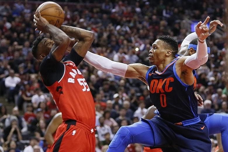 Oklahoma's Russell Westbrook (right), who recorded a fifth straight triple-double, defends against Toronto's Delon Wright during the Thunder's 132-125 victory.