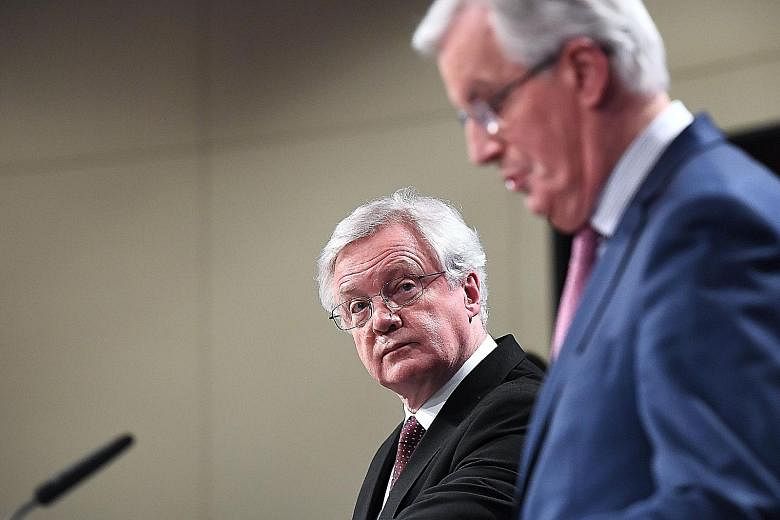 British Brexit minister David Davis (far left) and EU chief negotiator Michel Barnier addressing the media after their meeting at the European Commission in Brussels yesterday. The purpose of the transition period is to give businesses and citizens t