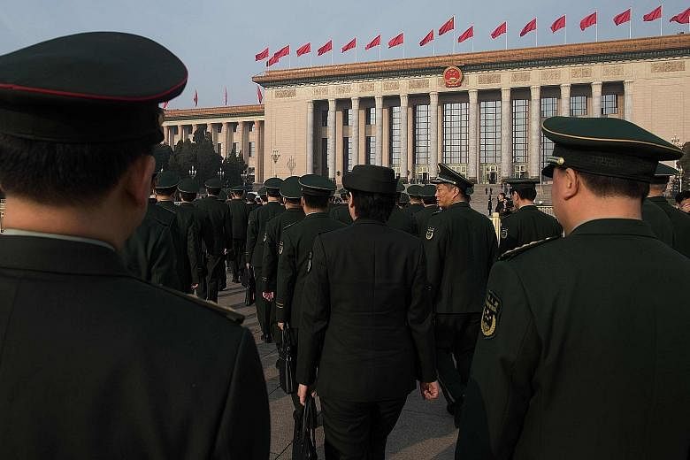 Military delegates arriving for the seventh plenary session of the National People's Congress at the Great Hall of the People in Beijing yesterday. The appointment of General Wei Fenghe as defence minister completed the shake-up of top military offic