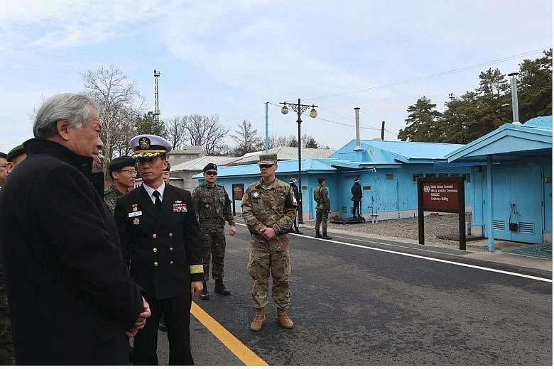 Defence Minister Ng Eng Hen (far left) at the heavily fortified Korean Demilitarised Zone (DMZ) yesterday. The DMZ divides the two Koreas, which are technically in a state of war.